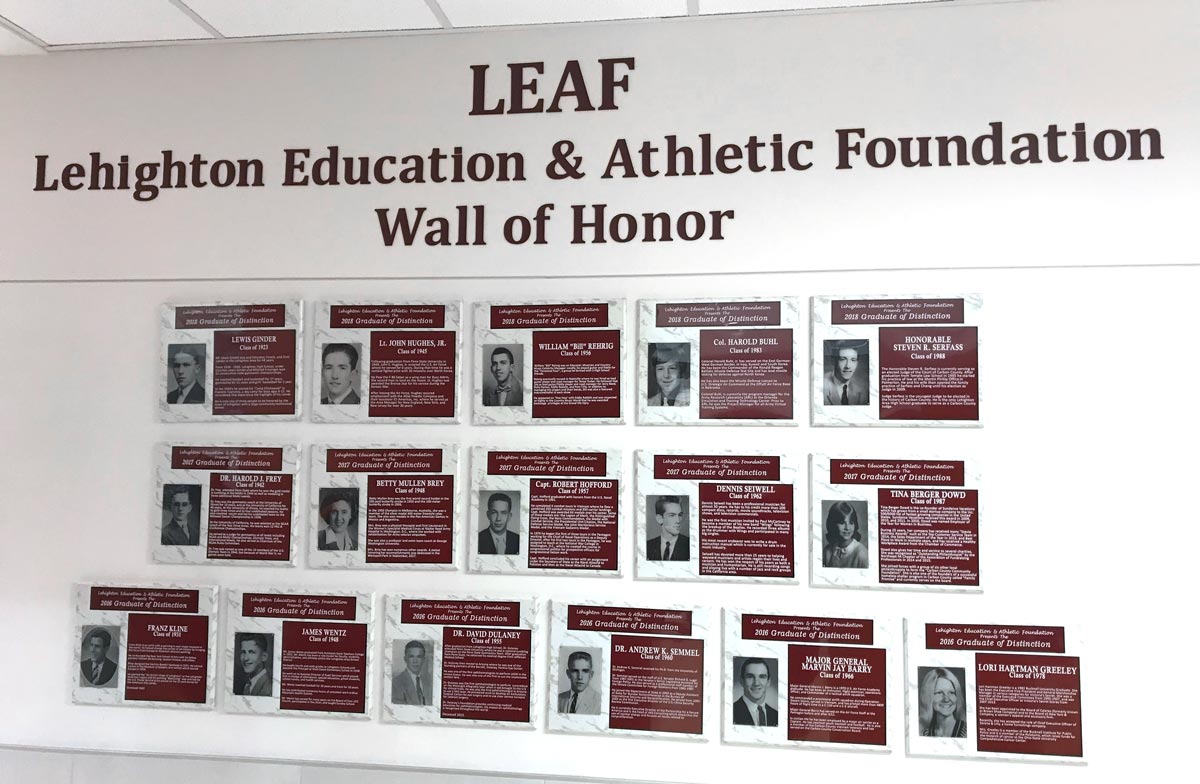 The LEAF Wall of Honor, featuring many honorary plaques lining a wall.